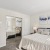 a bedroom with a bed and a mirror