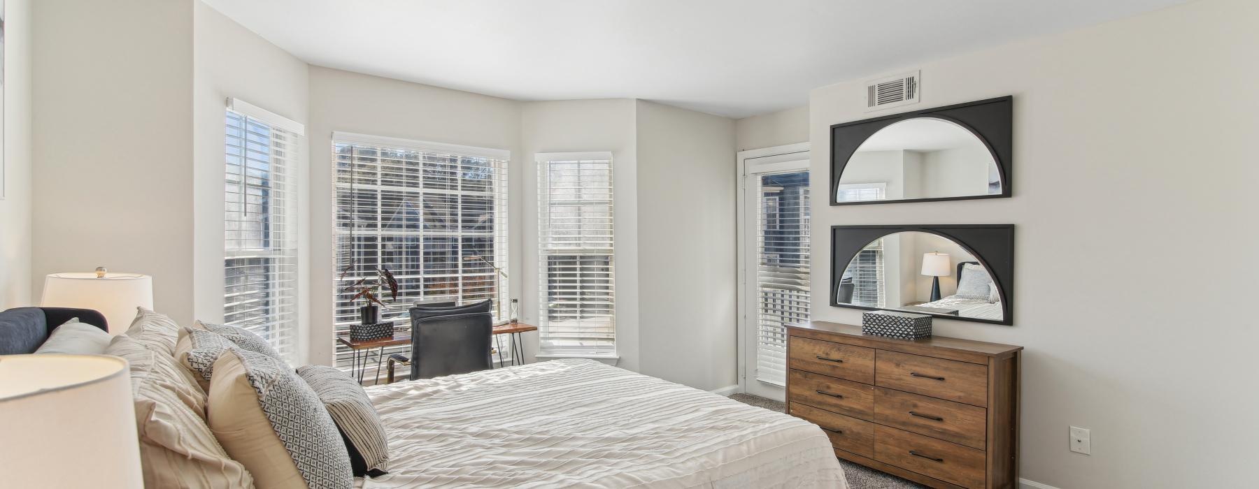 a bedroom with a bed and a mirror