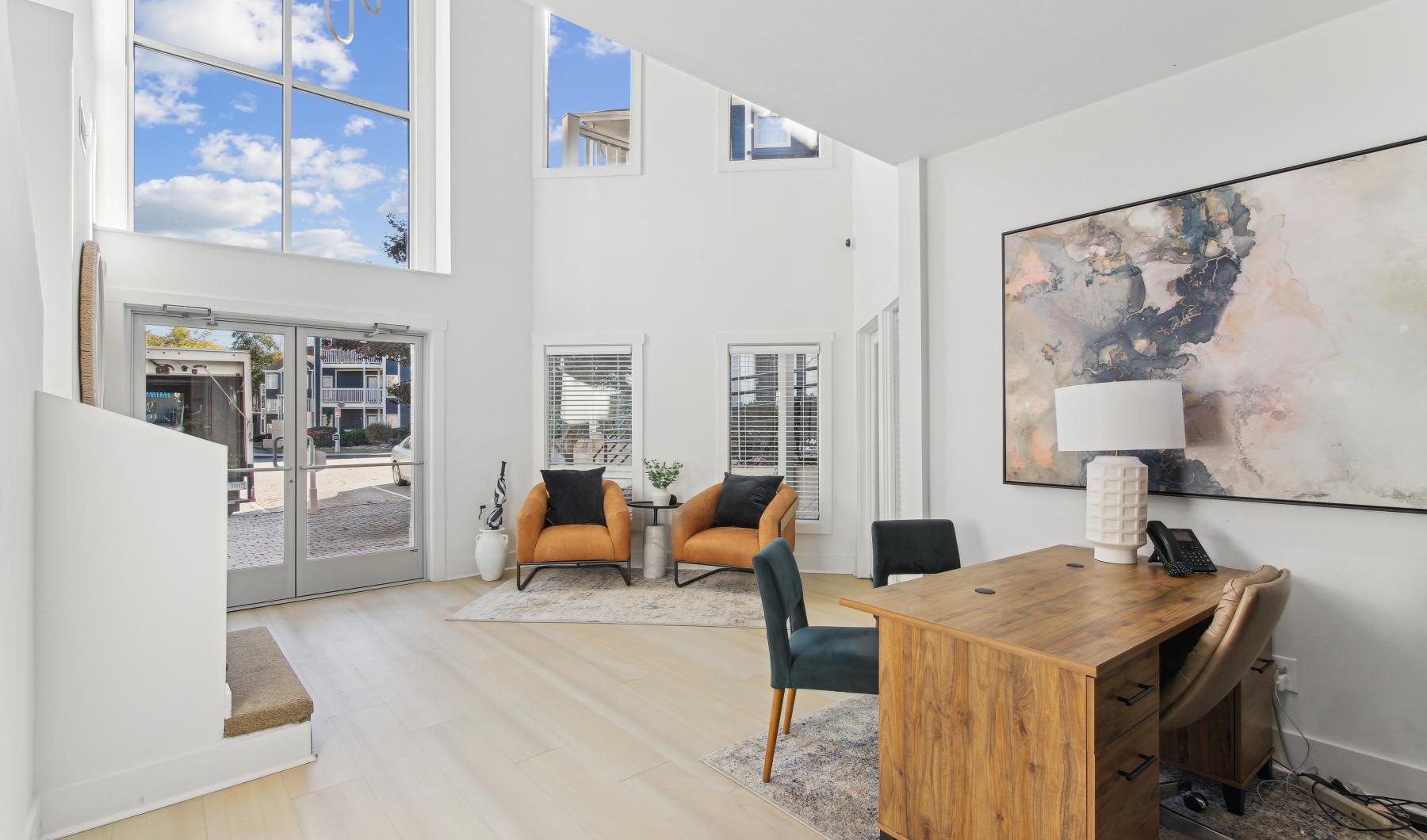 a leasing office room with a desk and chairs