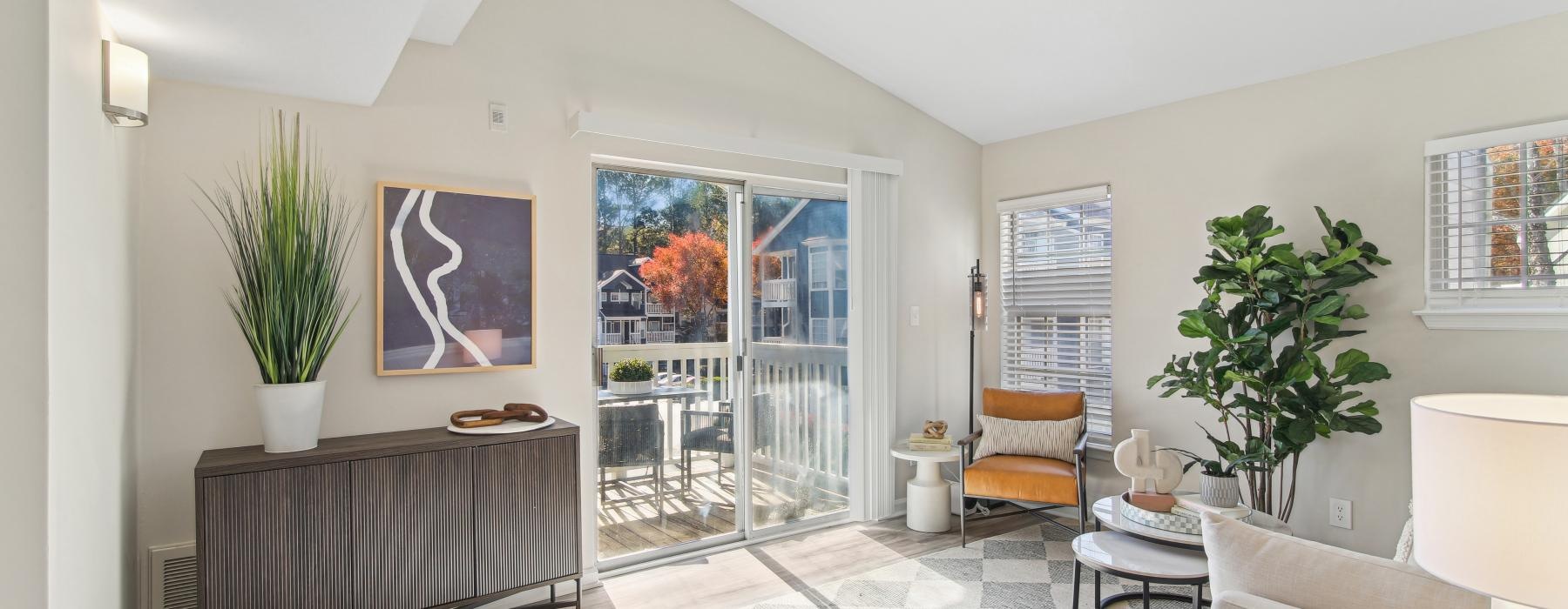 a room with a glass door and a plant in it